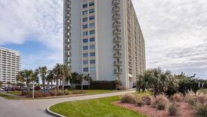 A tall, modern hotel with multiple balconies and a well-maintained lawn. - Spectacular OCEAN VIEWS - Fabulous Kingston South Hampton 3rd fl unit (Myrtle Beach)