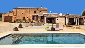 A two-story stone building with a swimming pool in front. - Historic finca with modern comfort and panoramic views, pool, calm nature, WiFi (Son Serra de Marina)