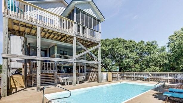 A two-story building with a pool, outdoor seating, and a wooden deck. - Even Steven | 570 ft from the beach | Private Pool | Duck (Duck)