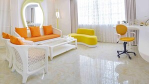 A modern living room with a white sofa, yellow armchair, and a white coffee table. - Floloving Hotel (Guangzhou)