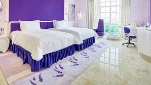 A modern bedroom with a large bed, a vanity, and a desk. - Floloving Hotel (Guangzhou)