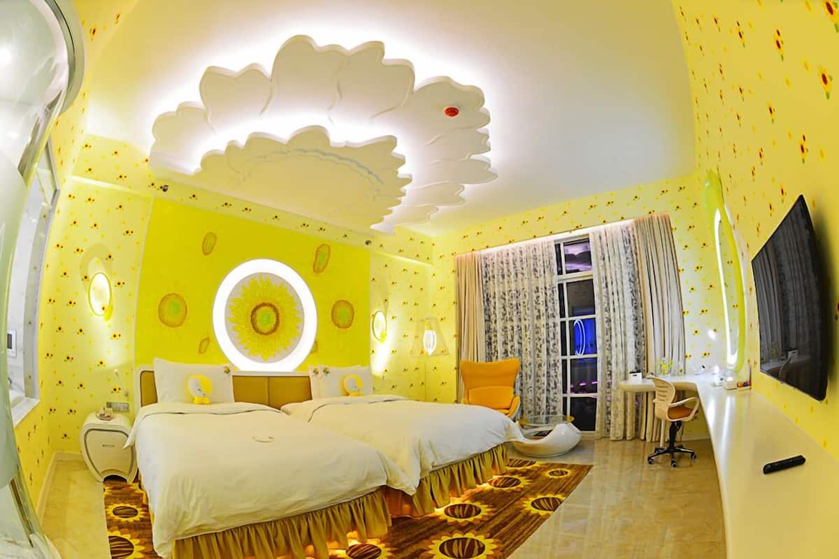 A room with a bed, a desk, and a TV.
