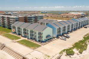Hotel rooms offer expansive views of the surrounding landscape and body of water.