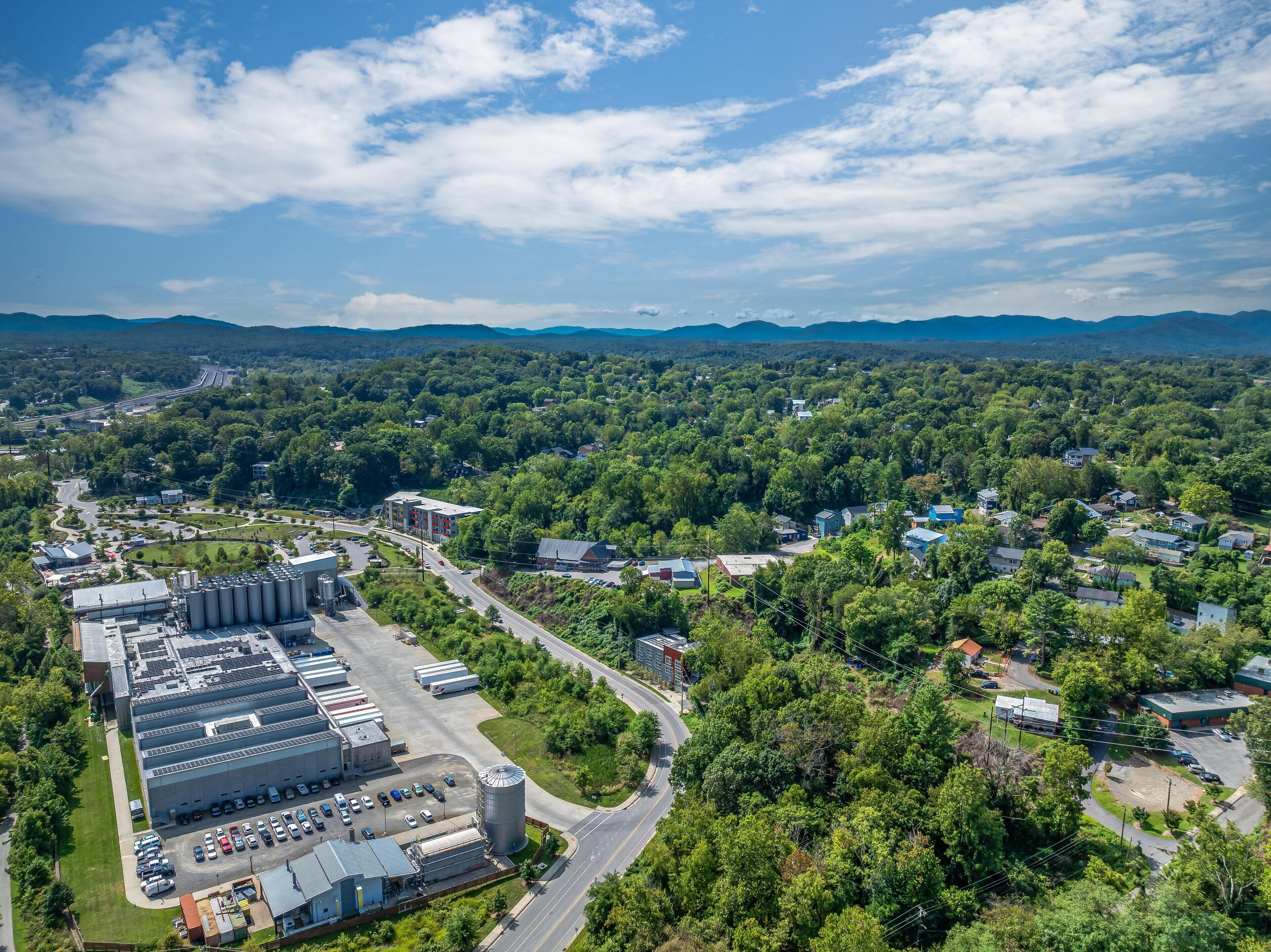An industrial area with large warehouses, a parking lot, and a road network.