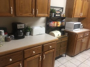 Enjoy a well-equipped kitchen with a toaster, coffee maker, and microwave.