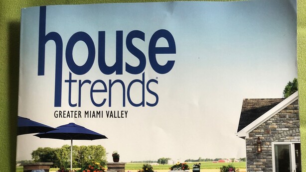 A brochure cover for a house trends feature in Greater Miami Valley, highlighting a home crown retreat in Wilmington with a stone patio, outdoor seating, and a pool.