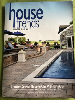 A brochure cover for a home retreat in Wilmington, featuring a pool, outdoor seating, and a stone building.
