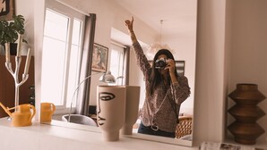 A person taking a selfie in a room with a large mirror, a window, and a plant. - Stylish 2 bedroom apart. with breathtaking private Rooftop, garage (Nîmes)