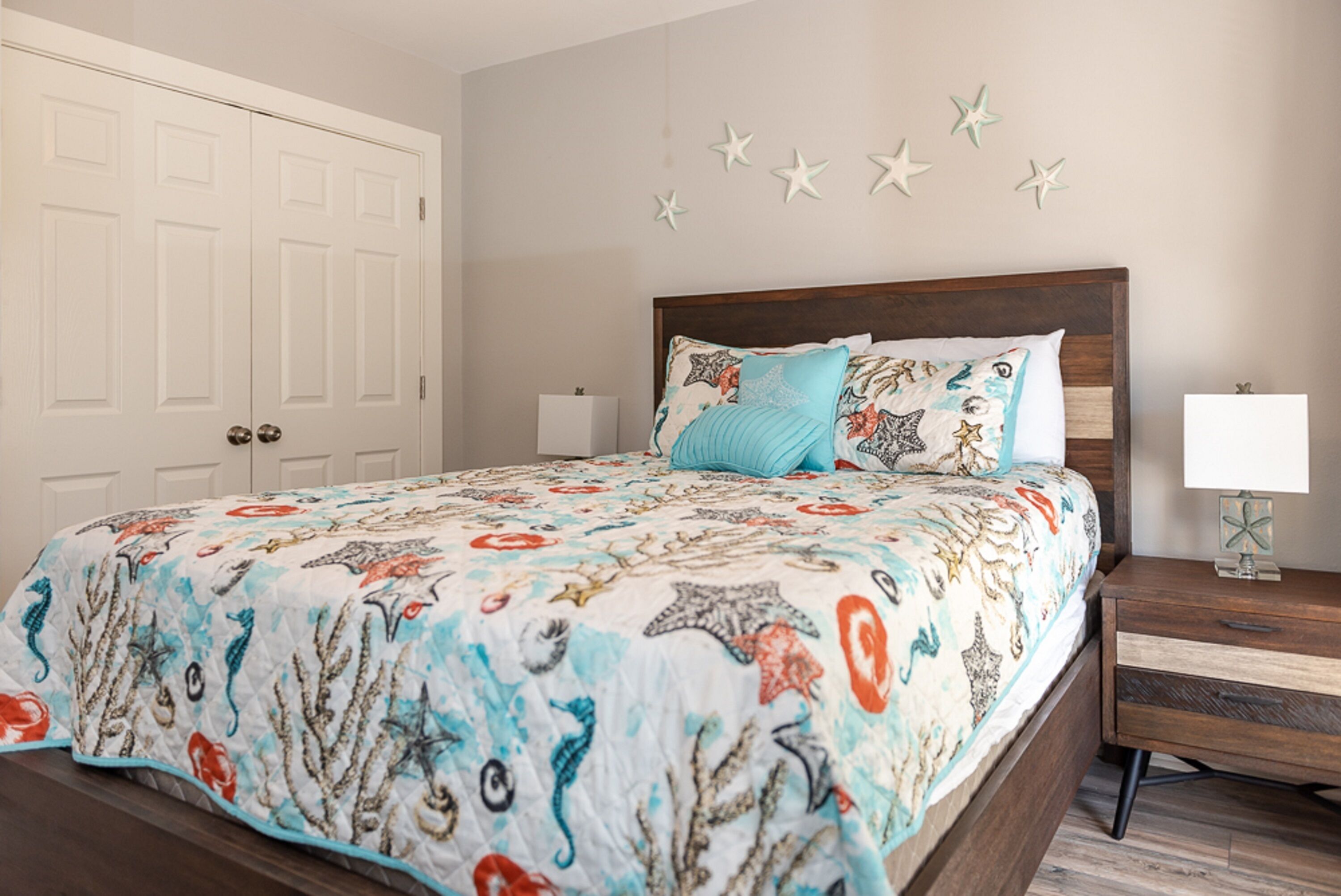 A bedroom with a bed, nightstand, and wardrobe.