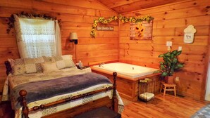 A wooden cabin bedroom with a four-poster bed, a large bathtub, and a potted plant. - ❤ VERY ROMANTIC CABIN ❤ Near Cades Cove, WIFI, Hot Tub, Jacuzzi, Sauna (Townsend)