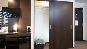 A hotel room with a desk, a flat-screen TV, a wardrobe, and a hanging closet. - Hotel Kojan Shinsaibashi (Osaka)