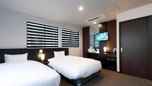 A hotel room with two beds, a TV, a desk, and a wardrobe. - Hotel Kojan Shinsaibashi (Osaka)