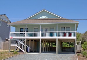 A two-story house with a balcony, a staircase, and a garage. - Beach Bofs - Classic 4BR Home on the 2nd Row; Covered Porch! (Surf City)