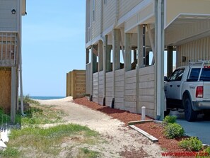 Beachfront property with ocean views, featuring a partially constructed building and a sandy beach.