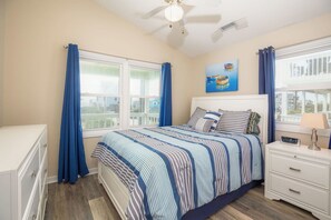 A bedroom with a bed, a nightstand, a dresser, a ceiling fan, and a window with curtains. - Beach Bofs - Classic 4BR Home on the 2nd Row; Covered Porch! (Surf City)