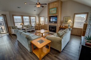 Relax in this stylish living room with a sofa set, coffee table, and wall-mounted TV.