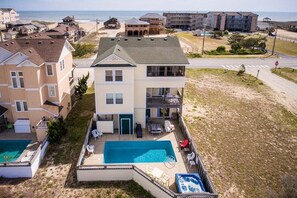Enjoy a balcony with pool and patio views overlooking the beach.