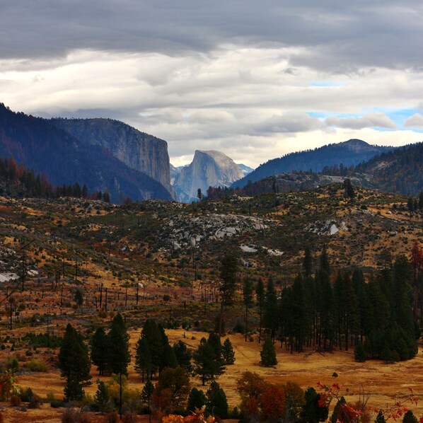 Un paisaje montañoso con una destacada formación rocosa a lo lejos.