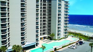 A high-rise hotel with multiple balconies, a swimming pool, and a beach view. - Angle Oceanfront Family Suite at Resort + Official On-Site Rental Privileges (Myrtle Beach)