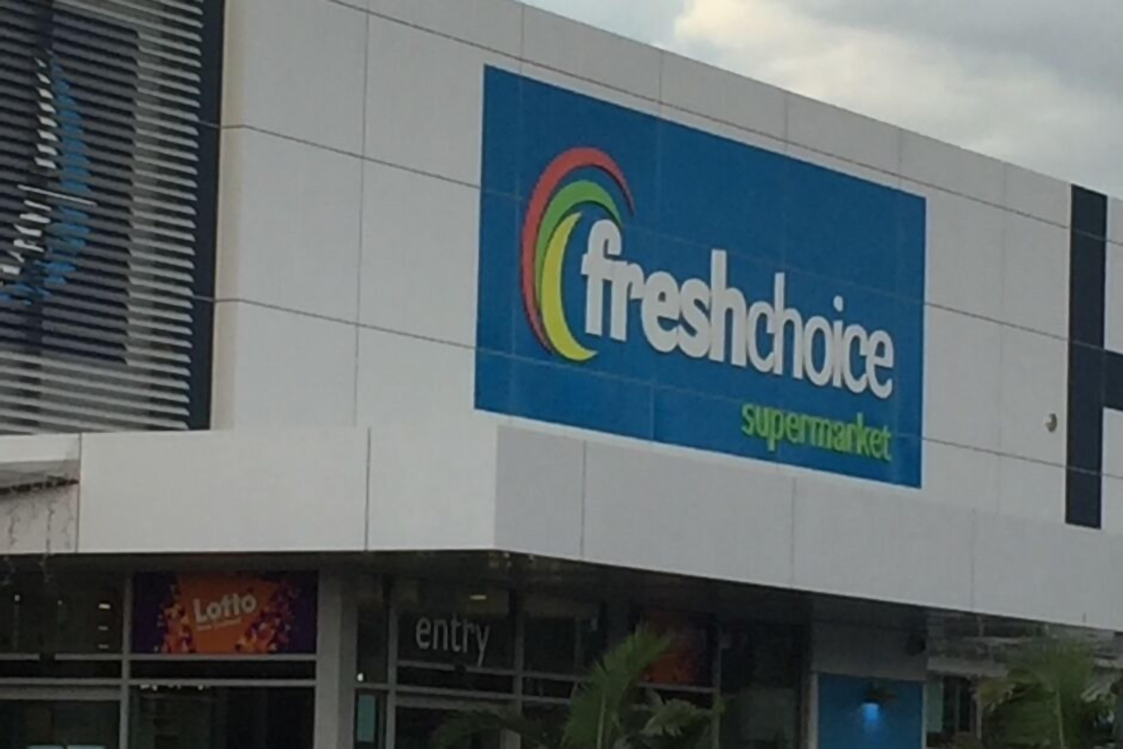 A FreshChoice supermarket with a prominent blue sign.