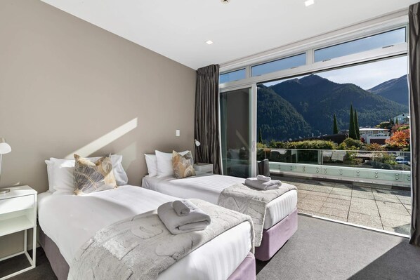 A hotel room with two beds, a large window with a mountain view, and a balcony with a railing. - Edgar Rise, 500m from Queenstown CBD (Queenstown Hill)