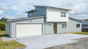 Stunning two-story home with a garage and beautifully manicured lawn.