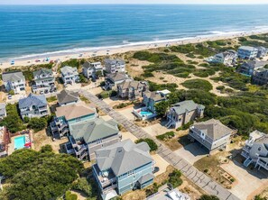 A coastal residential area with houses, a beach, and a clear view of the ocean. - Pelican's Perch | 320 ft from the beach | Private Pool, Hot Tub | Corolla (Corolla)
