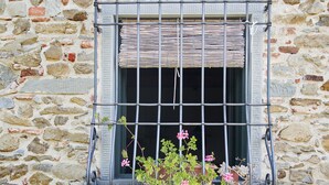 A stone wall with a window featuring metal bars and shutters. - "The fireplace"discover the Tuscan peculiarities getting lost in landscapes (Vicchio)