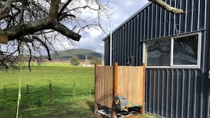 A wooden structure with a generator outside a building with a window. - Full holiday home to yourself, up to 21 guests (Atiamuri)