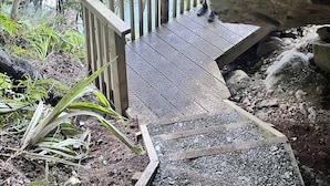 A wooden staircase leading up to a rocky overhang. - Somers holiday cottage (Mt Somers)