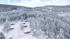 A snow-covered forest with several red cabins. - Amazing home in Sysslebäck with kitchen (Sysslebäck)