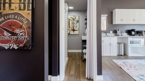 A modern kitchen with white cabinets, a coffee machine, and a tiled backsplash. - Stay Close to Culture & Sports Venues in a Spacious & Stylish Butterfly Studio (Phoenix)