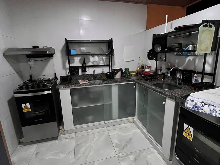 A compact kitchen with a gas stove, a microwave, and a sink.