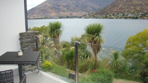 A balcony with a view of a lake and mountains. - 3 LEVEL LAKESIDE LUXURY WITH MAGNIFICENT LAKE & MOUNTAIN VIEWS POTENTIAL CARHIRE (Frankton)