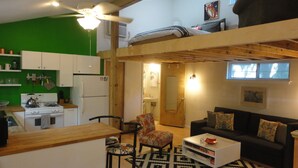 A compact living space with a kitchenette, a sofa, a coffee table, and a patterned rug. - Best Central Location/Private Urban Oasis/ Travis Heights Near SoCo & Downtown (Austin)