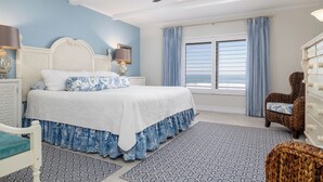 A bedroom with a bed, a chair, a dresser, and a window with curtains. - Bring swim suit and start your beach holiday in this well appointed 2 bedroom 2 bath 3rd floor condo (New Smyrna Beach)