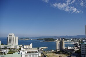 A coastal cityscape with buildings, a clear sky, and a view of the sea. - Shirahama Ocean View 6 (西牟婁郡白浜町)