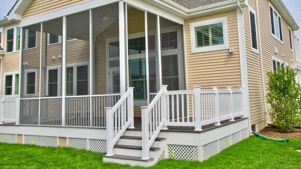 A two-story house with a covered porch, a front entrance with steps, and a small garden area. - Coastal Club * 6 BR Twin Lewes Beach Home rentals (Lewes)