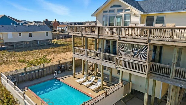 A two-story house with a pool and outdoor seating. - Sea Spirit | 717 ft from the beach | Dog Friendly, Private Pool, Hot Tub | Kitty Hawk (Kitty Hawk)