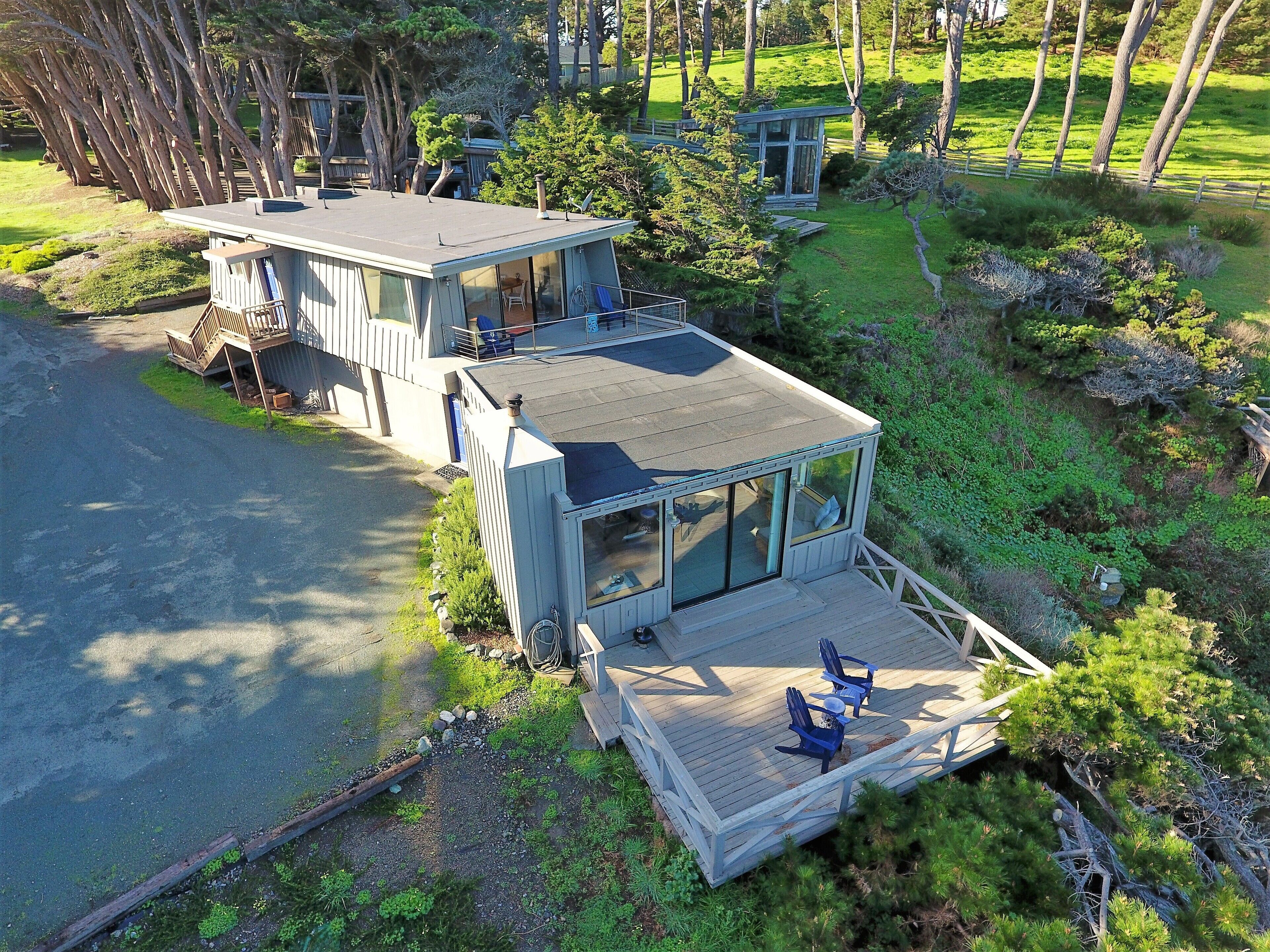 A modern house with a large deck and a covered patio area.