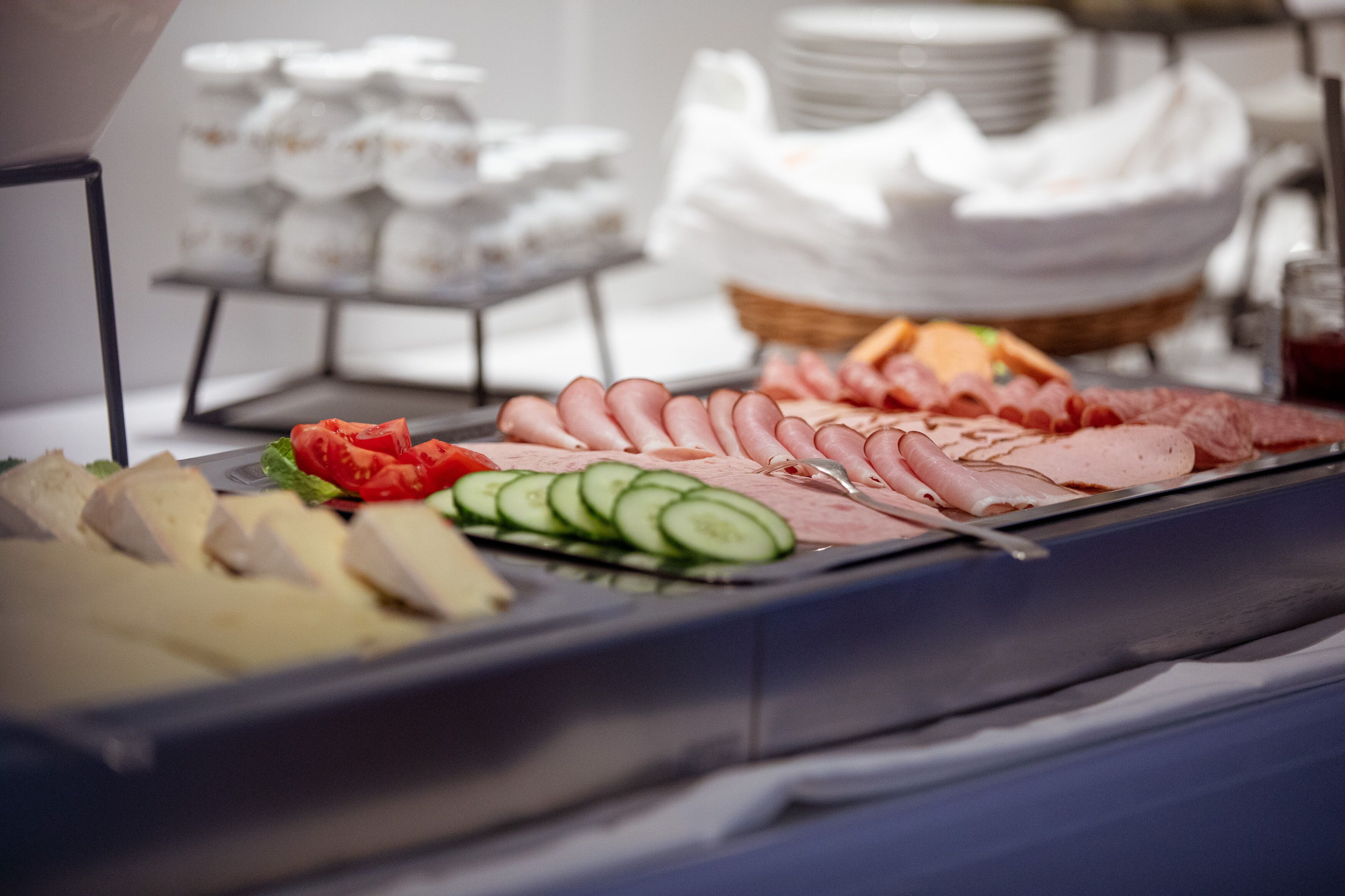 Een buffet met diverse vleessoorten, kazen en groenten.