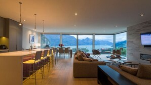 A modern living room with a large window overlooking a scenic mountain view.