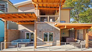 A multi-level house with a covered patio, a hot tub, and a deck with seating. - Upstream Bachelorette Oasis - DOWNTOWN LOCATION! (Asheville)