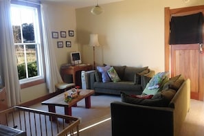 Relax in this inviting living room with a sofa, coffee table, and wall-mounted TV.