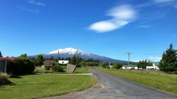 A rural road with a mountain in the background.