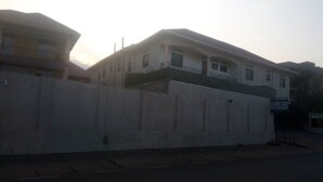 A two-story building with a balcony on the second floor. - Belize Motel (Kigali)