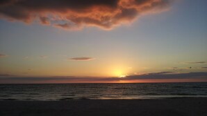 A sunset over the ocean with clouds in the sky. - Historic Home/Apt... (Tarpon Springs)