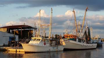 Two fishing boats docked at a marina with a building in the background.