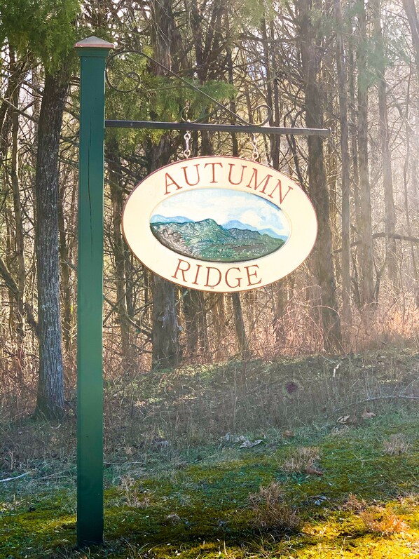 A sign reading "AUTUMN RIDGE" with a landscape illustration.