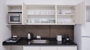 A modern kitchen with a built-in oven, a coffee maker, a toaster, and a sink. - TPYN Palermo (Buenos Aires)